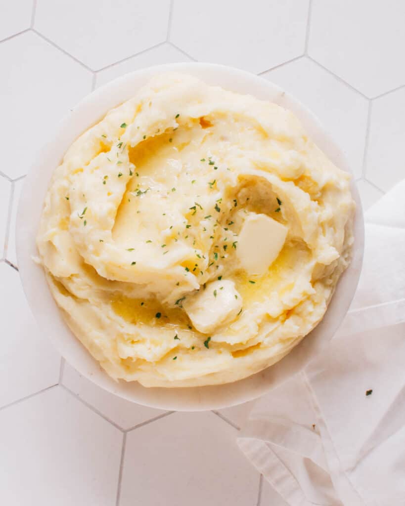 Mashed potatoes in a bowl with butter.